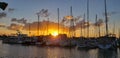 Sunrise marina boats sun clouds