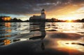 Sunrise in medieval city Vyborg. Beautiful reflections of st Olaf castle and sun in baltic water