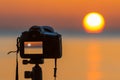 A camera photographs the sunrise and the photographed image can be seen in the display. Royalty Free Stock Photo