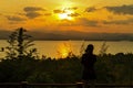 Sunrise morning with black shadow of traveler on lagoon and mountain