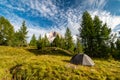 Sunrise morning view of green tent and Tofane mountains Tofana di Rozes in background. Autumn camping in Dolomites, Trentino Alto