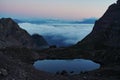 Sunrise in the mountains, Ausrtian Alps view shelter on peack. Pinky sky with clouds, mirroring in lake. Area for hiking and Via Royalty Free Stock Photo