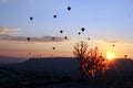 The sunrise in the mountains with a lot of air hot balloons in the sky. Royalty Free Stock Photo