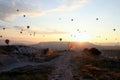 The sunrise in the mountains with a lot of air hot balloons in the sky. Royalty Free Stock Photo