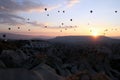 The sunrise in the mountains with a lot of air hot balloons in the sky. Royalty Free Stock Photo