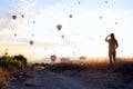 The sunrise in the mountains with a lot of air hot balloons in the sky. Royalty Free Stock Photo