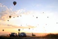 The sunrise in the mountains with a lot of air hot balloons in the sky. Royalty Free Stock Photo