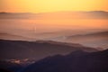 Sunrise in mountains, shape of hills in morning mist, white edit space Royalty Free Stock Photo