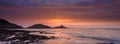 Sunrise on the Mumbles Light House from Bracelet Bay, Gower Peninsula, Wales, UK Royalty Free Stock Photo