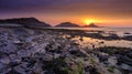 Sunrise on the Mumbles Light House from Bracelet Bay, Gower Peninsula, Wales, UK Royalty Free Stock Photo