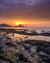 Sunrise on the Mumbles Light House from Bracelet Bay, Gower Peninsula, Wales, UK Royalty Free Stock Photo