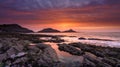 Sunrise on the Mumbles Light House from Bracelet Bay, Gower Peninsula, Wales, UK Royalty Free Stock Photo