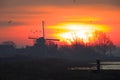 A sunrise in the Netherlands with a typical Dutch landscape and geese taking off.