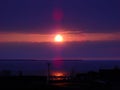 Sunrise in the north. Cloudy morning with the dawn over Lake Onega. On the horizon are the Ivanovo Islands. Factory buildings on Royalty Free Stock Photo