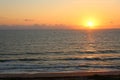 Sunrise on the Ocean with Boat and Beach