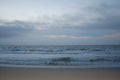 Sunrise on the ocean, white sky, and sand