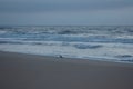 Sunrise on the ocean, white sky, and sand