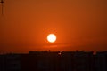 Sunrise orange coloured sky Sun clouds. Buildings silhouette photography black Crane machinary. Construction site foreground. Royalty Free Stock Photo