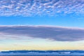 Beautiful morning sky in Greenland over Arctic Ocean with icebergs near Ilulissat. Altocumulus floccus and stratiformus clouds. Royalty Free Stock Photo