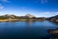 Sunrise over beautiful and huge blue lake with blue sky and big limestone mountains. Porma reservoir. Leon Mountains Royalty Free Stock Photo