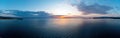 Sunrise over calm ocean aerial panorama. Sunset orange and blue color cloudy sky. Chalkidiki, Greece Royalty Free Stock Photo