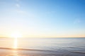 sunrise over calm ocean with clear blue sky Royalty Free Stock Photo