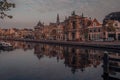 Sunrise over a canal at a windmill in the Netherlands Amsterdam. ships anchored in the port Royalty Free Stock Photo