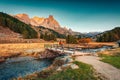 Sunrise over Claree valley and male tourist walking through wooden bridge in autumn at French Alps, France Royalty Free Stock Photo