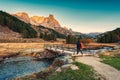 Sunrise over Claree valley and male tourist walking through wooden bridge in autumn at French Alps, France Royalty Free Stock Photo