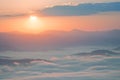 Sunrise over clouds of fog in the mountains. Royalty Free Stock Photo