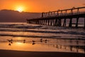 Sunrise over the clouds with jetty and seagulls Royalty Free Stock Photo