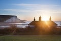 Sunrise over coastguard cottages at Seaford Head with Seven Sisters in background