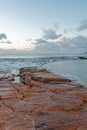 Sunrise over rocky coast at Dale Brook Tidal Swim Pool seawall in Cape Town South Africa SA Royalty Free Stock Photo