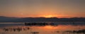 Sunrise over Dojran Lake and fisherman between reeds Royalty Free Stock Photo