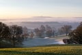 Sunrise over the english countryside on a misty winters day. Royalty Free Stock Photo