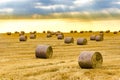 Sunrise over farm field with hay bales Royalty Free Stock Photo