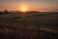 Sunrise over a farm field in early fall Royalty Free Stock Photo