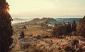 Sunrise over fields of Tuscany. Wineyards, garden trees, villas of countryside at early morning time, Italy Royalty Free Stock Photo