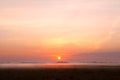 Sunrise over fog on pasture Royalty Free Stock Photo