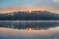 Sunrise over the foggy lake Royalty Free Stock Photo