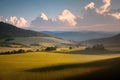 Sunrise over green grass land with hills and clouds Royalty Free Stock Photo