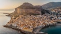 Sunrise over harbor in Cefalu, Sicily, Italy, panoramic aerial view of old town with colorful waterfront houses, sea and La Rocca Royalty Free Stock Photo