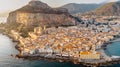 Sunrise over harbor in Cefalu, Sicily, Italy, panoramic aerial view of old town with colorful waterfront houses, sea and La Rocca Royalty Free Stock Photo