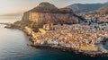 Sunrise over harbor in Cefalu, Sicily, Italy, panoramic aerial view of old town with colorful waterfront houses, sea and La Rocca Royalty Free Stock Photo