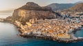 Sunrise over harbor in Cefalu, Sicily, Italy, panoramic aerial view of old town with colorful waterfront houses, sea and La Rocca Royalty Free Stock Photo