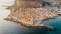 Sunrise over harbor in Cefalu, Sicily, Italy, panoramic aerial view of old town with colorful waterfront houses, sea and La Rocca Royalty Free Stock Photo