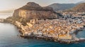 Sunrise over harbor in Cefalu, Sicily, Italy, panoramic aerial view of old town with colorful waterfront houses, sea and La Rocca Royalty Free Stock Photo