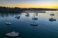 Sunrise over the harbour with low cloud bank and boats