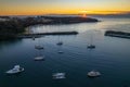 Sunrise over the harbour with low cloud bank and boats