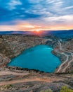 Sunrise over heart shaped blue quarry lake. Fluxing limestone Kadykovsky quarry, Balaklava, Crimea. One of the lowest points of